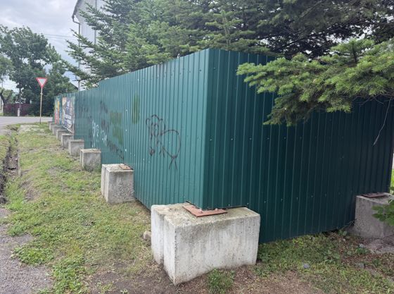Ограждение здания, расположенное по адресу: Приморский край, г. Уссурийск, ул. Октябрьская, д. 100.